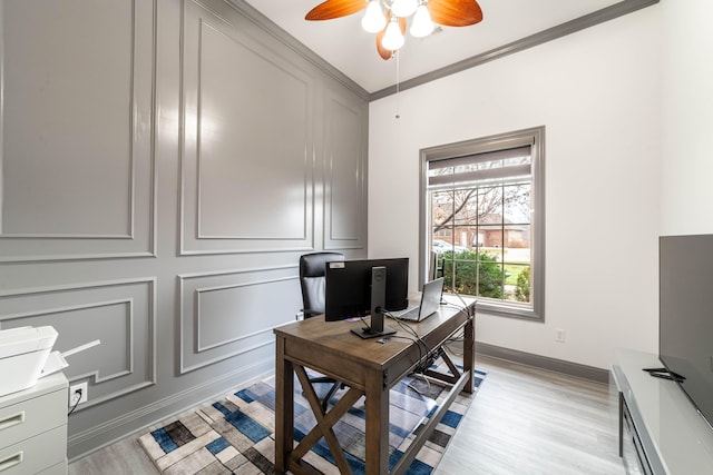 office space with ceiling fan, light hardwood / wood-style floors, and ornamental molding