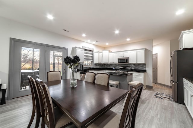 dining room featuring light wood-type flooring and sink