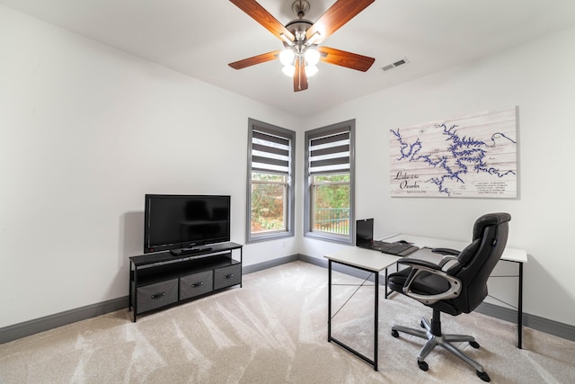 carpeted office space with ceiling fan