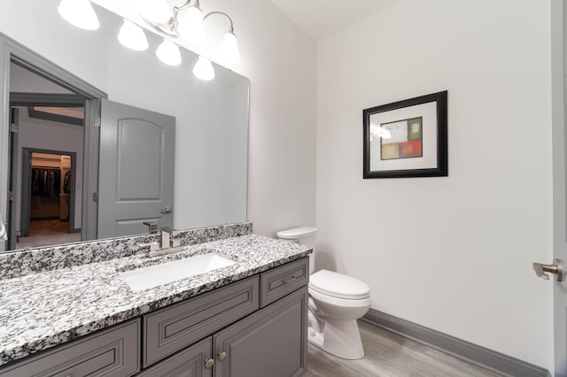 bathroom featuring hardwood / wood-style floors, vanity, and toilet