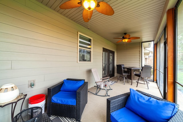 sunroom / solarium featuring ceiling fan