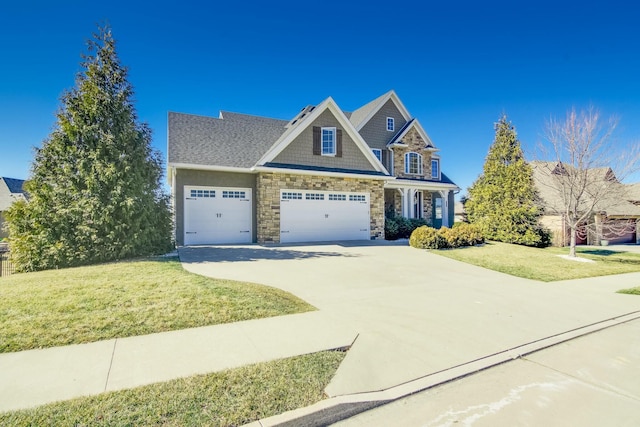 craftsman inspired home with a front yard, stone siding, driveway, and an attached garage