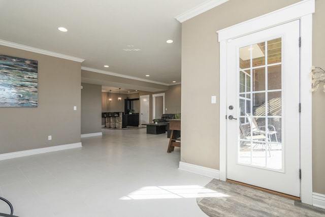 foyer entrance featuring ornamental molding, recessed lighting, and baseboards