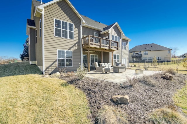 back of property with a patio, an outdoor hangout area, fence, a yard, and a wooden deck