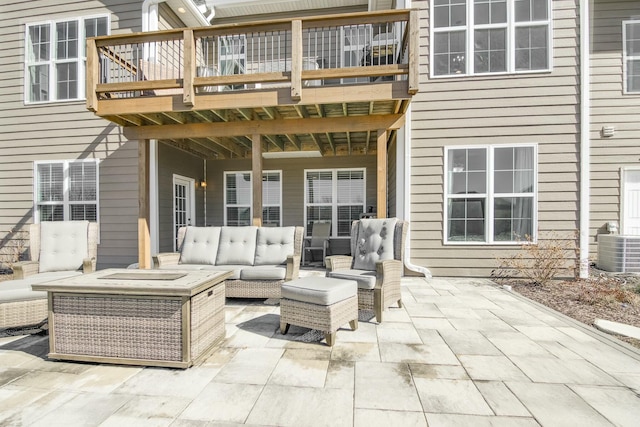 view of patio featuring cooling unit, outdoor lounge area, and a balcony