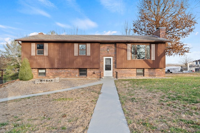 raised ranch with a front yard