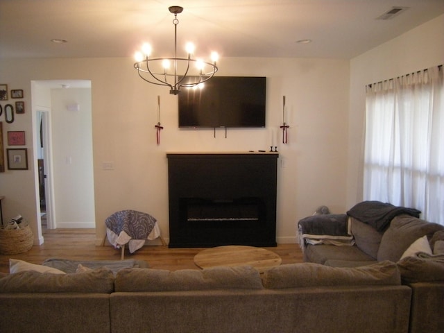 living room with wood-type flooring and a notable chandelier