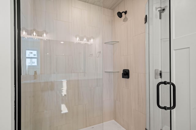 bathroom with a shower with door