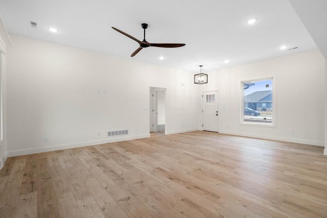 unfurnished living room with ceiling fan and light hardwood / wood-style floors