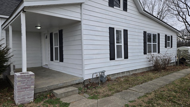 view of side of home with a porch