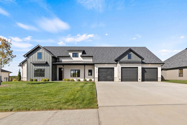 modern inspired farmhouse featuring a garage and a front yard