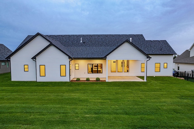 back of house featuring a patio and a lawn