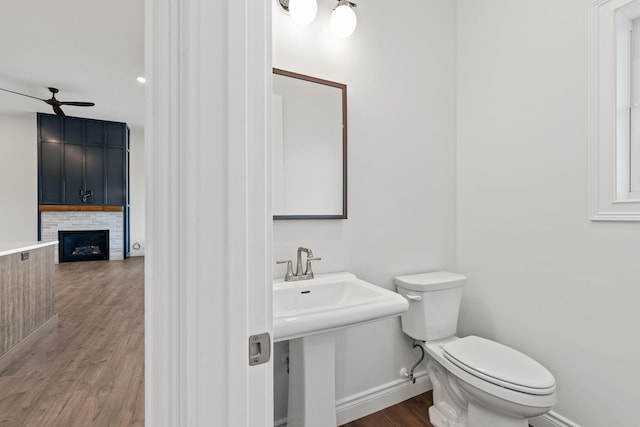 bathroom featuring ceiling fan, hardwood / wood-style flooring, and toilet