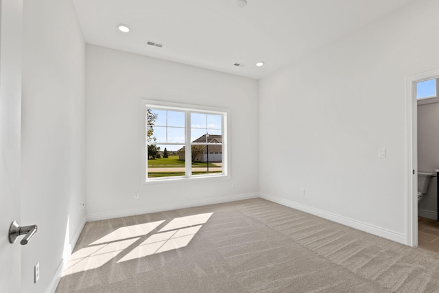 unfurnished room featuring light colored carpet