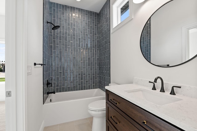 full bathroom with toilet, tile patterned flooring, vanity, and tiled shower / bath