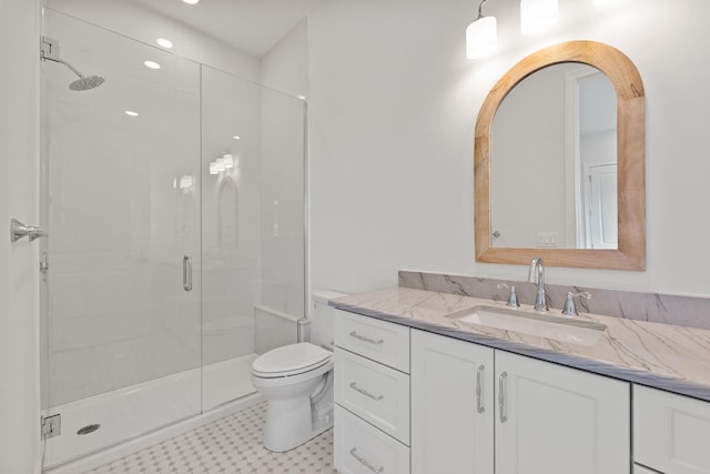 bathroom with vanity, an enclosed shower, and toilet