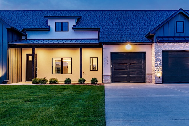 view of front of home featuring a garage and a front lawn