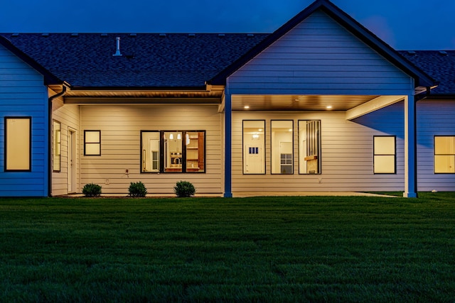 back of house featuring a yard