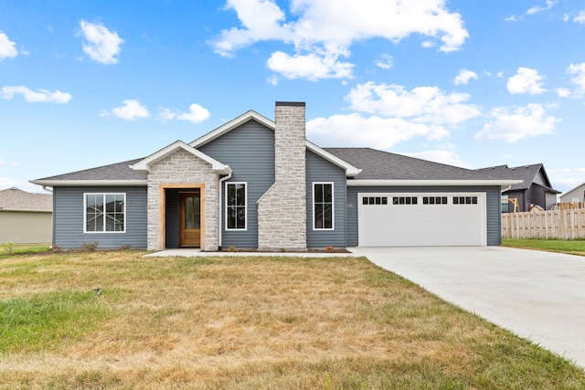 view of front of home featuring a front yard and a garage