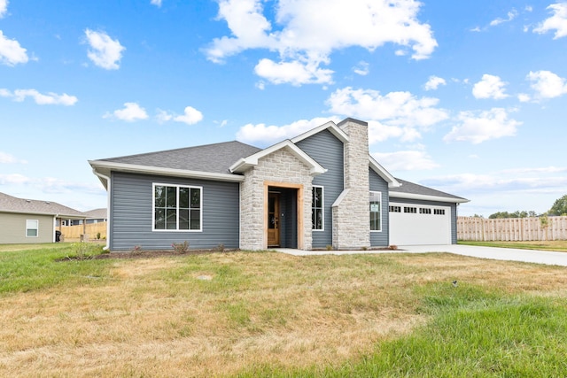 view of front of home with a garage and a front lawn