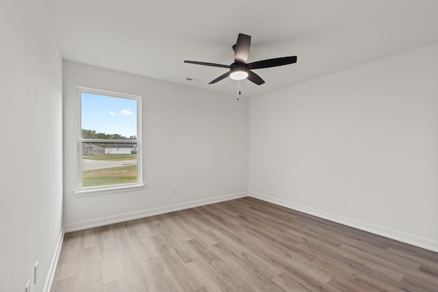 empty room featuring ceiling fan and light hardwood / wood-style flooring