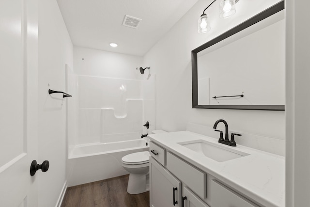 full bathroom featuring shower / tub combination, hardwood / wood-style floors, vanity, and toilet