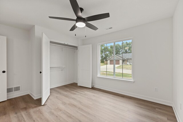 unfurnished bedroom featuring a closet, ceiling fan, and light hardwood / wood-style flooring