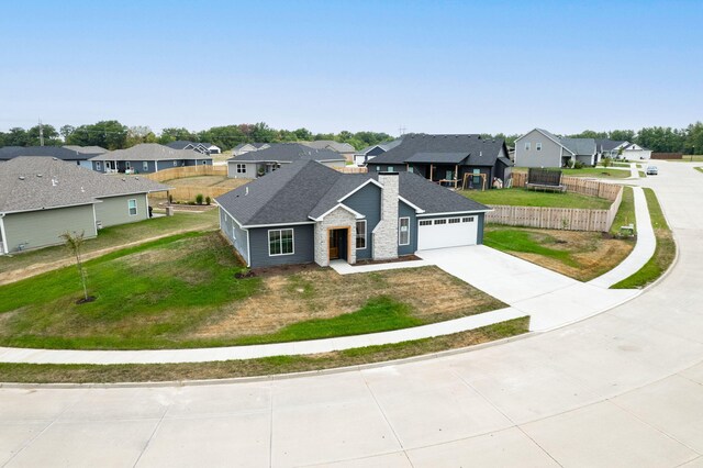 view of front of home with a front lawn and a garage