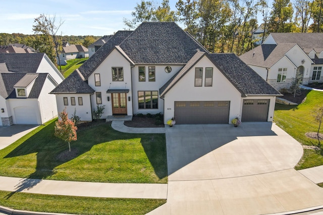 view of front of home with a front lawn and a garage