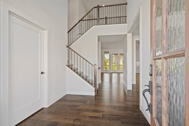 entrance foyer with dark wood-type flooring and a high ceiling