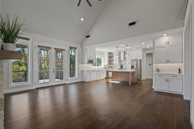 unfurnished living room featuring ceiling fan, sink, high vaulted ceiling, and dark hardwood / wood-style floors