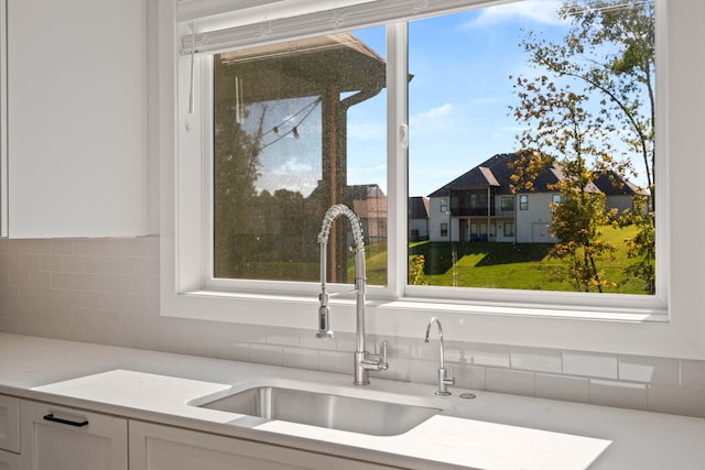 interior space with white cabinetry and sink