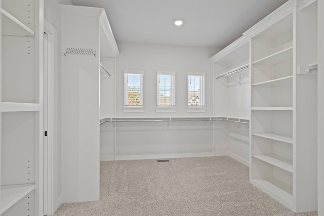 walk in closet with carpet flooring