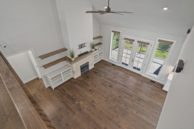 unfurnished living room with french doors, vaulted ceiling, ceiling fan, and dark wood-type flooring