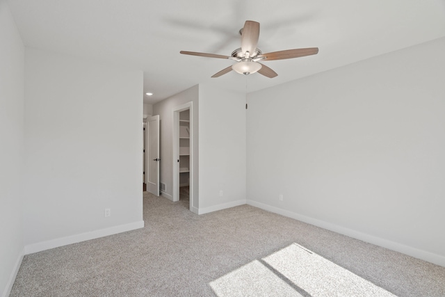 spare room with light carpet and ceiling fan