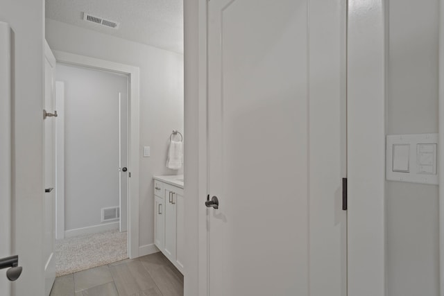 bathroom featuring vanity and a textured ceiling