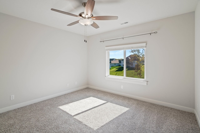 empty room featuring ceiling fan and carpet floors