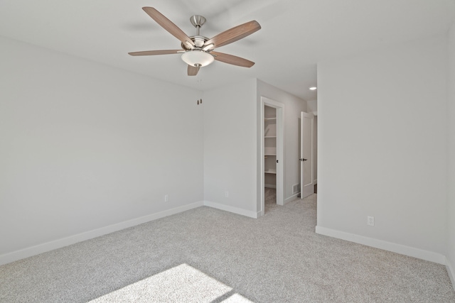 carpeted empty room featuring ceiling fan