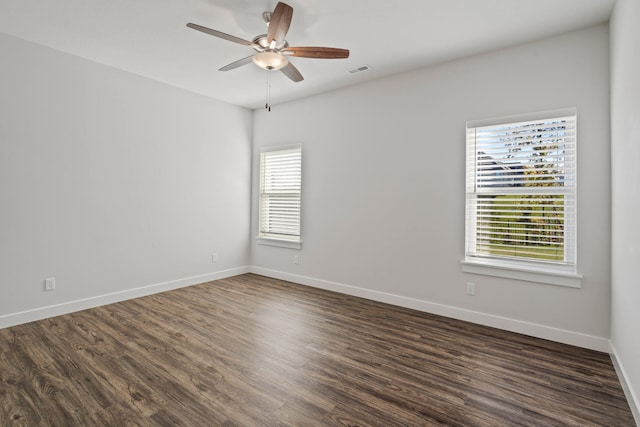 unfurnished room with ceiling fan, dark hardwood / wood-style flooring, and a healthy amount of sunlight