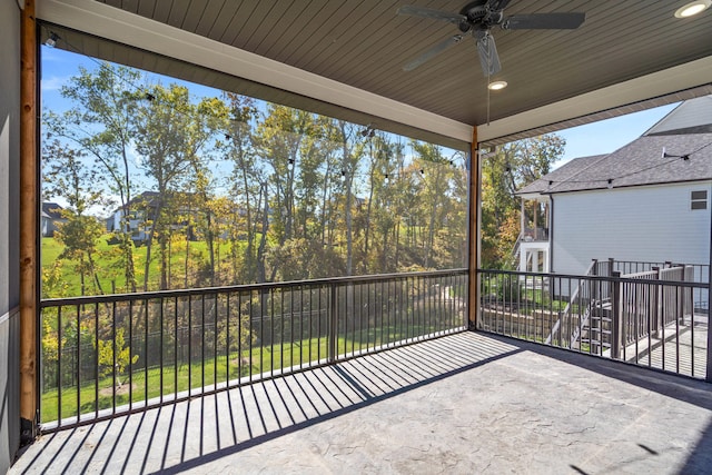 unfurnished sunroom featuring ceiling fan