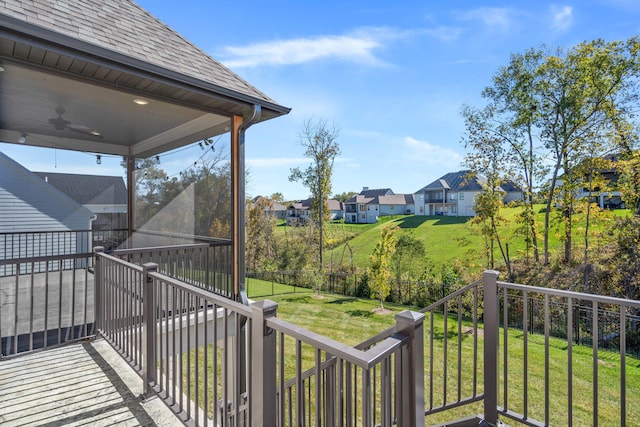 exterior space featuring ceiling fan and a yard