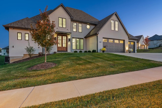 view of front of property with a front yard and french doors