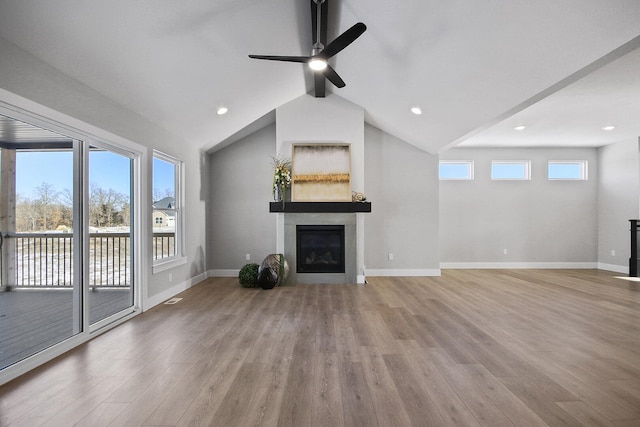 unfurnished living room featuring light hardwood / wood-style floors, a wealth of natural light, and ceiling fan