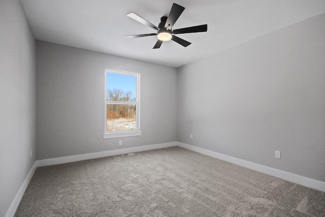 spare room with ceiling fan and carpet floors