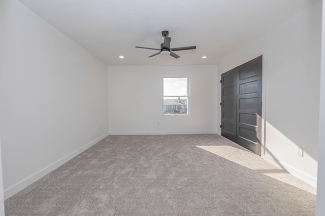 interior space featuring recessed lighting, ceiling fan, baseboards, and carpet floors