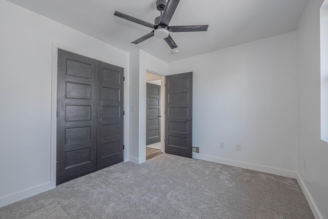 unfurnished bedroom featuring baseboards, carpet floors, and a ceiling fan