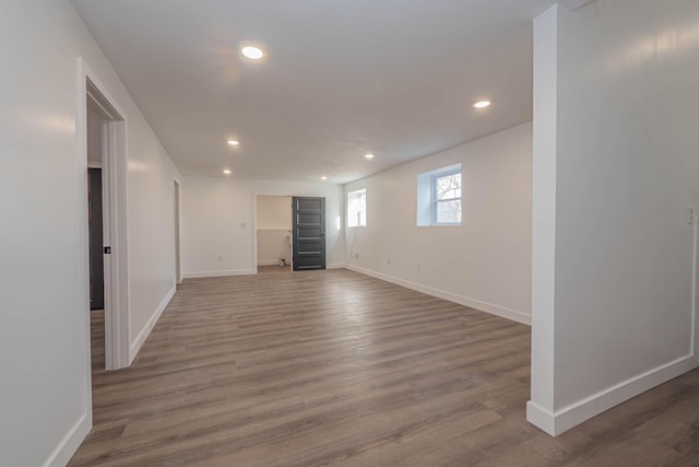 interior space featuring recessed lighting, wood finished floors, and baseboards