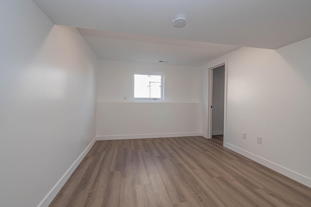 interior space with baseboards and wood finished floors