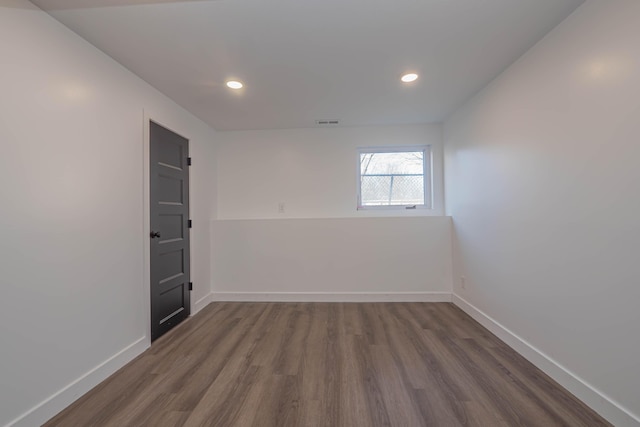 empty room with recessed lighting, visible vents, baseboards, and dark wood finished floors