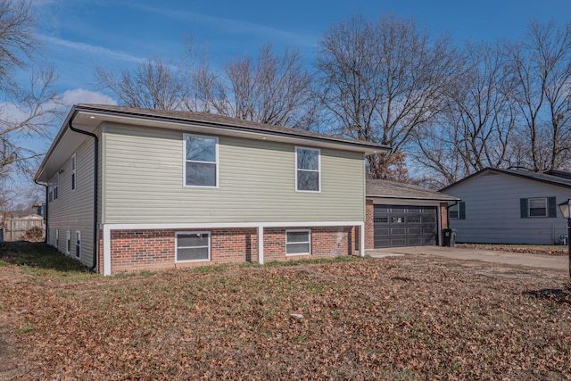 view of side of home with driveway and a garage